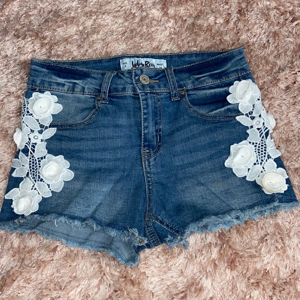 White flower cutoff jean shorts